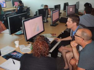 teachers working on computers while at workshop