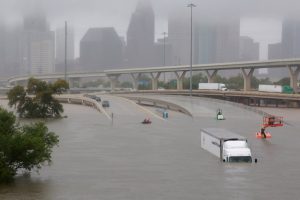 Scene showing freeways flooded and vehicles stranded, near downtown Houston.